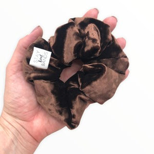 dark brown velvet scrunchie in hand